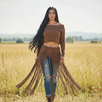 Woman wearing a multi-purpose macrame skirt from the brand altysan, with brown fringes in a field