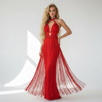 Woman wearing a red evening gown with fringe details on a white background