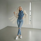 Woman wearing handmade macramé sleeve denim jacket with white fringe details and custom boho design