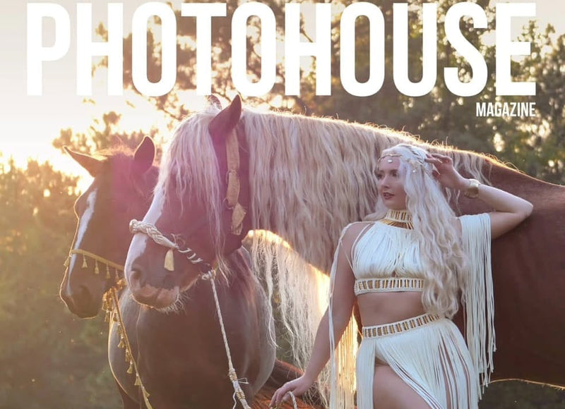 Woman in a white fringe macrame dress standing next to a horse in a field, with 'PHOTOHOUSE' magazine branding.