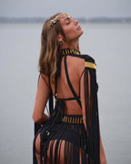 Back view of black macramé halter gown showing open-back construction and fringe