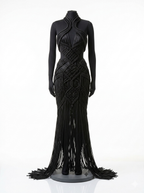 Long-sleeve black macrame couture gown displayed on mannequin, hand-knotted detail