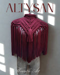 Macrame top with fringe details on a mannequin against a white wall with 'ALTYSAN' branding.