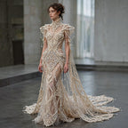 Luxury crystal beaded wedding dress with sheer bodice and dramatic train, hand-embellished couture bridal gown