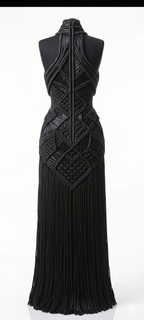 Full-length black macrame couture gown on mannequin, floor-sweeping silhouette