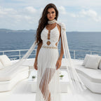 Woman in a white macrame dress with fringe details on a luxurious yacht with ocean view